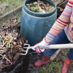 woman using gardening tool for compost pile